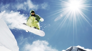 Snowboarder at jump inhigh mountains